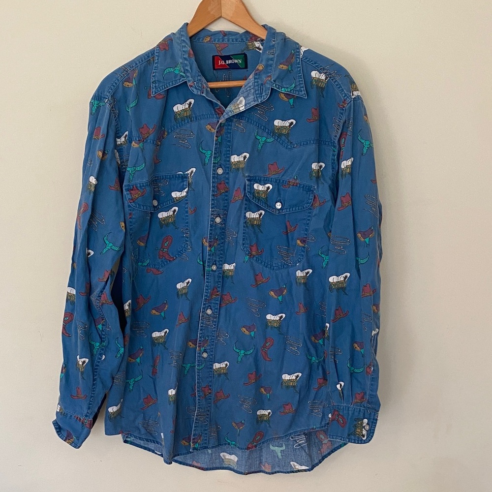Vintage denim western wear with cowboy print. Pearl buttons